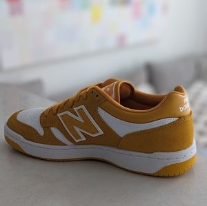 New Balance 480 White w/ Varsity Gold.     M's 7/W's 8.5 EU40